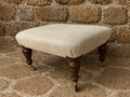 Victorian Upholstered Footstool with Castors – Antique Ottoman Stool, Turned Wood Legs, Neutral Fabric